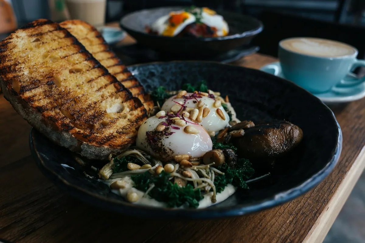 Delicious brunch featuring poached eggs with nuts and toast, perfect for food lovers.
